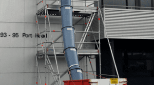 Rubbish chutes attached to scaffolding