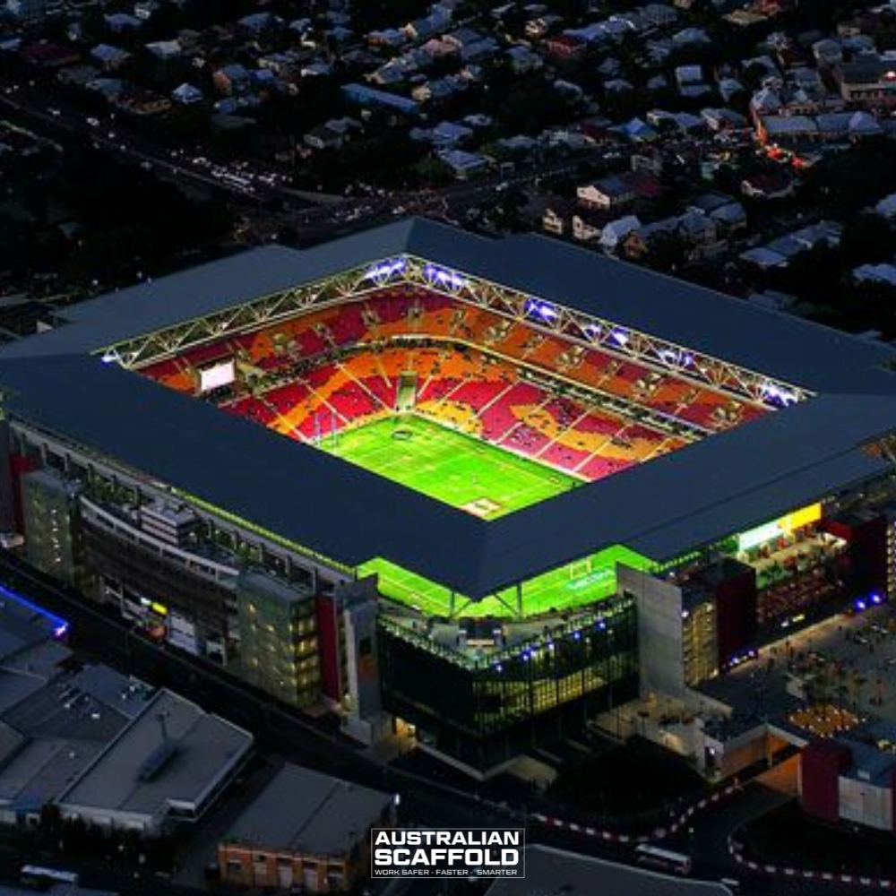 Aerial view of Lang Park Stadium at night, illuminated with bright lights