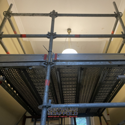 Scaffold on stairs for ceiling repairs